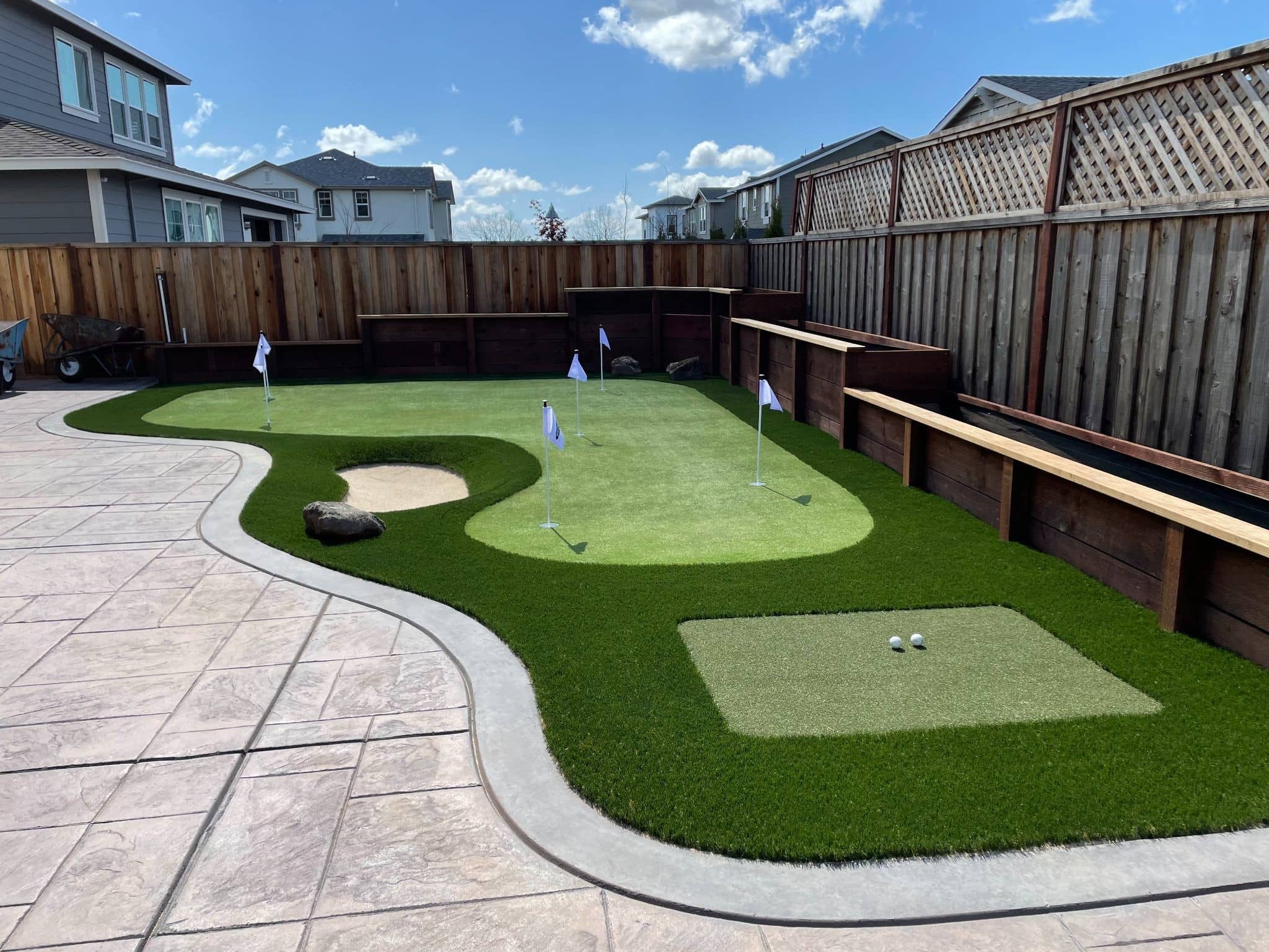 Backyard putting green with synthetic turf